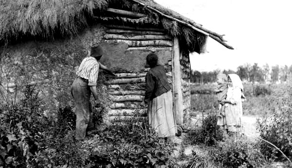 Joe Wacha and wife plastering their house near Vita, Manitoba, 1916, Manitoba Archives 